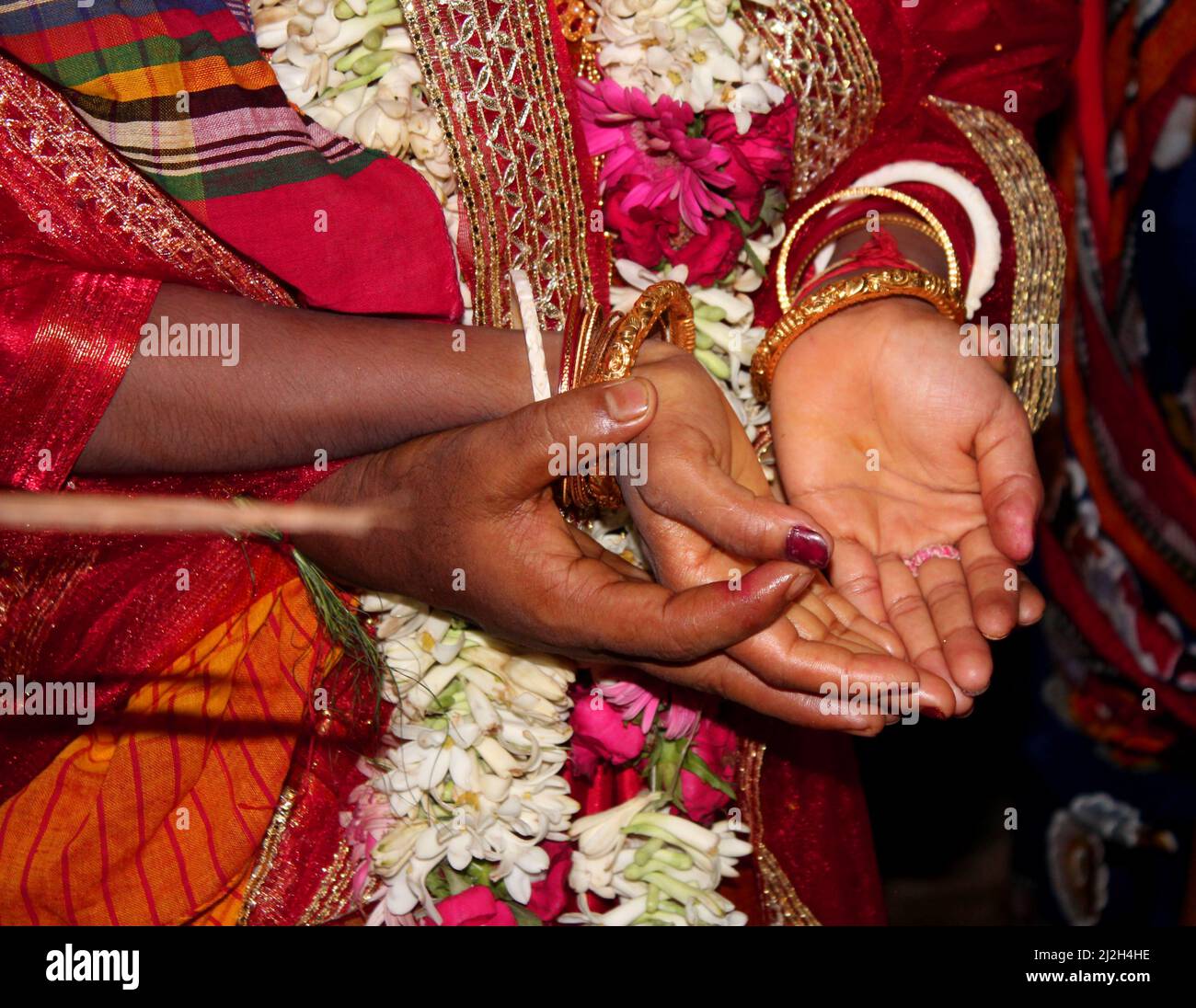 Traditional Bengali Hindu wedding ceremony, groom holding hand in bride hand. Selective focus Stock Photo