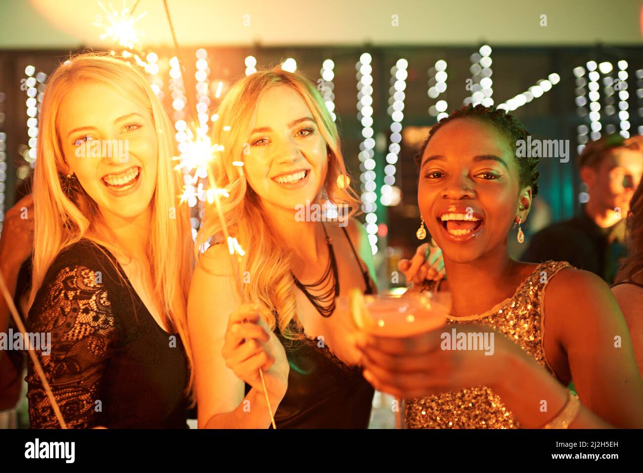 Because a little party never hurt anybody. Shot of a group of girlfriends having fun with sparklers on a night out. Stock Photo