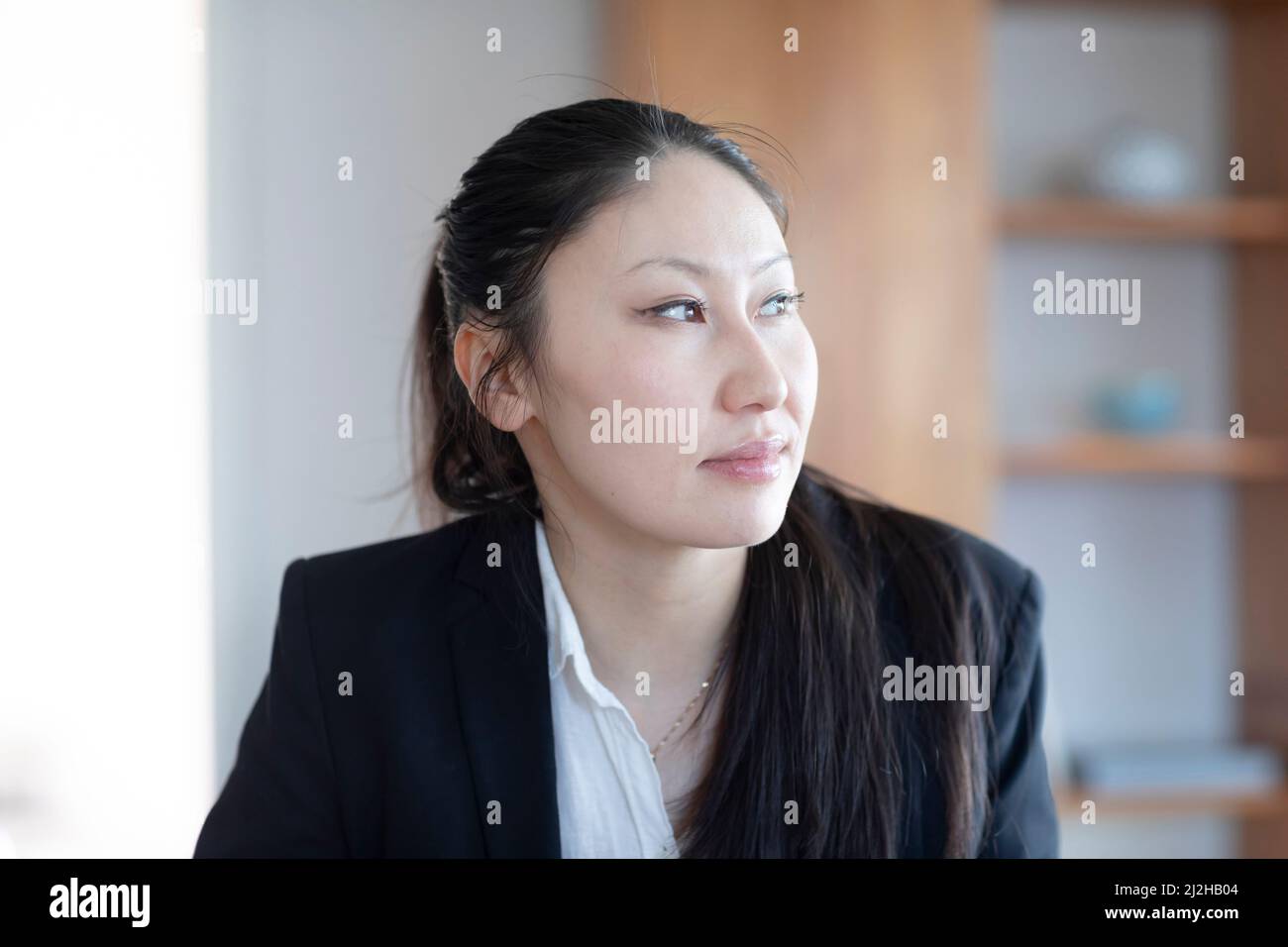 Pensive businesswoman with documents in office Stock Photo
