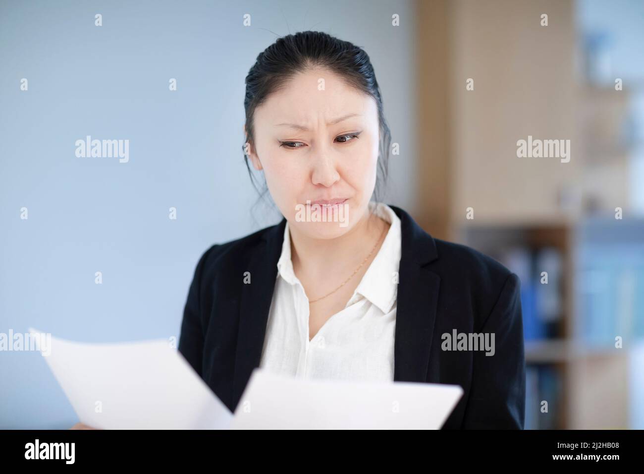 Businesswoman looking atÊdocuments in office Stock Photo