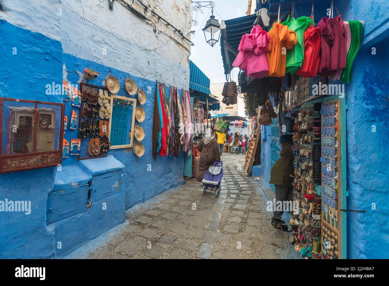 Morocco, Chefchaouen, Narrow alley and souvenirs for sale at