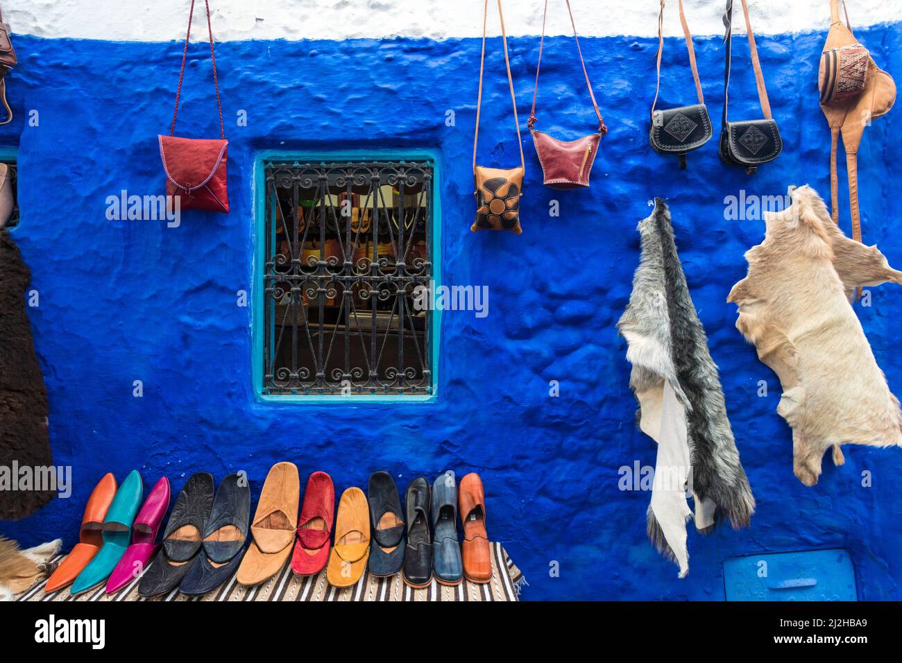Morocco, Chefchaouen, Souvenirs for sale at traditional blue building Stock Photo