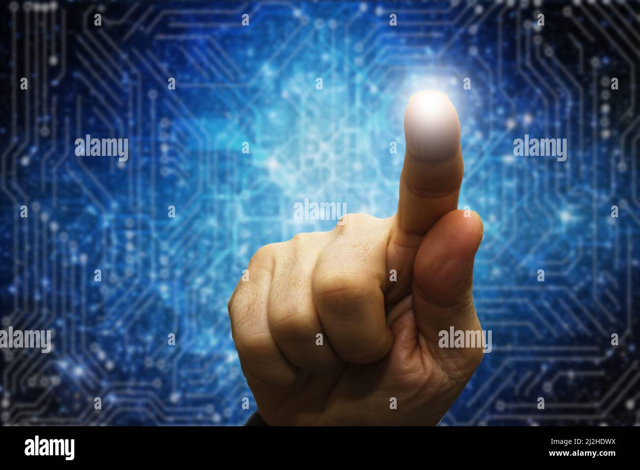 hand touching a screen with technology background Stock Photo