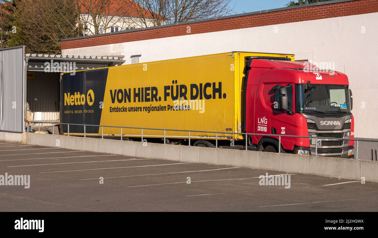Germany , Lübbenau , 13.03.2022 , A truck which runs on LNG  supplies a so-called scharzen Netto . Stock Photo