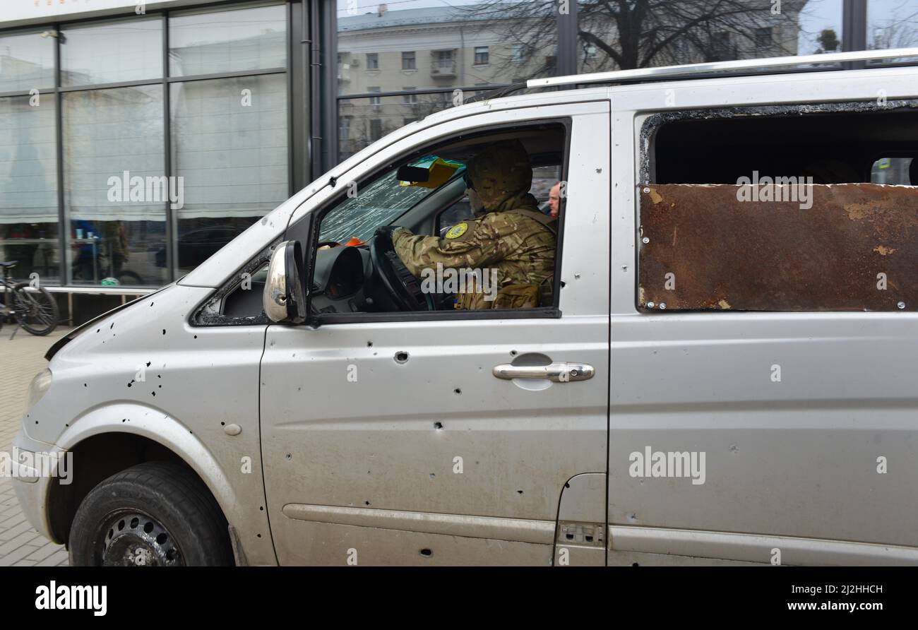 A minivan of defenders of Ukraine, beaten by russian shell fragments,  at the street of Kharkiv, Ukraine. Stock Photo
