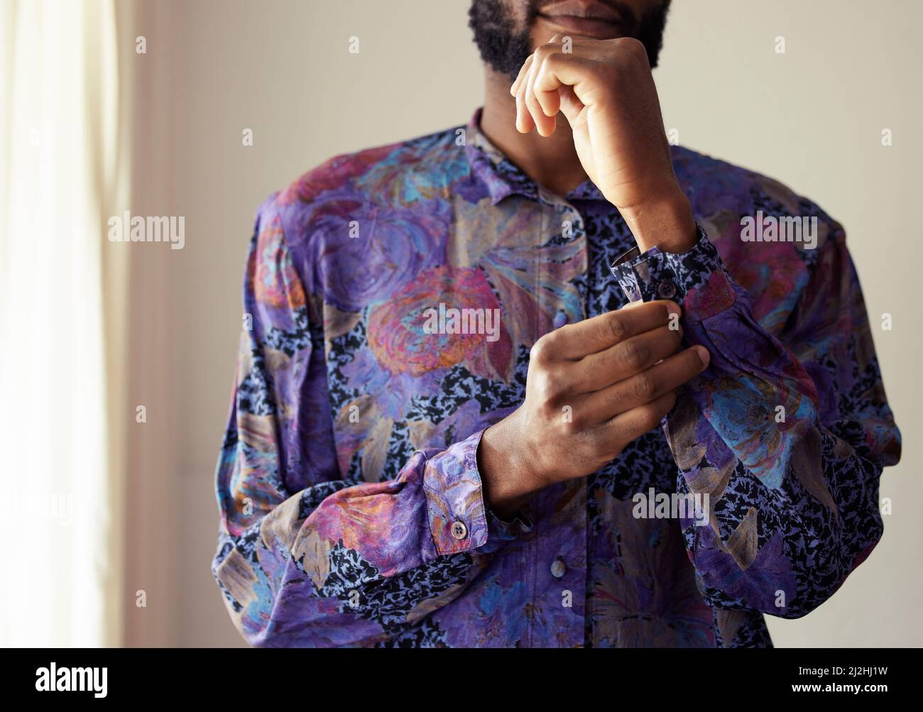 Dont I look dapper. Shot of an unrecognizable man buttoning a shirt at home. Stock Photo