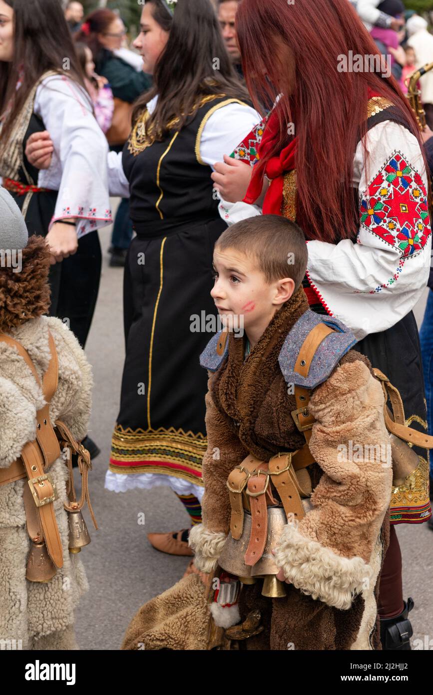 Bulgarian boy at the Kukeri mystical traditional millennium old winter festival in Sofia, Bulgaria, Balkans, Eastern Europe. Kukeri is a centuries-old tradition intended to chase evil spirits away and to invite good, held around early winter or midwinter. Stock Photo