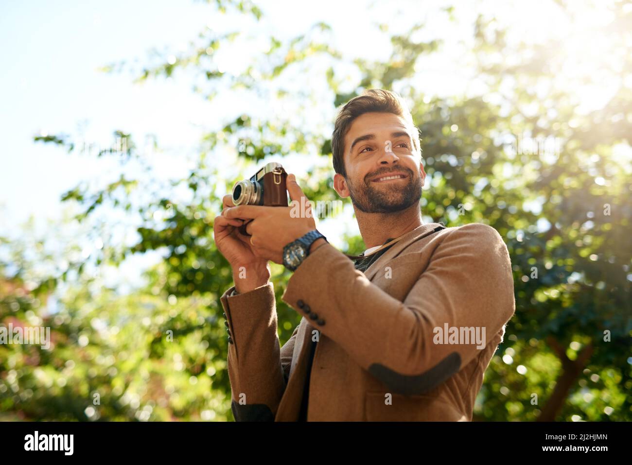 Happy man taking photos walking hi-res stock photography and images - Alamy