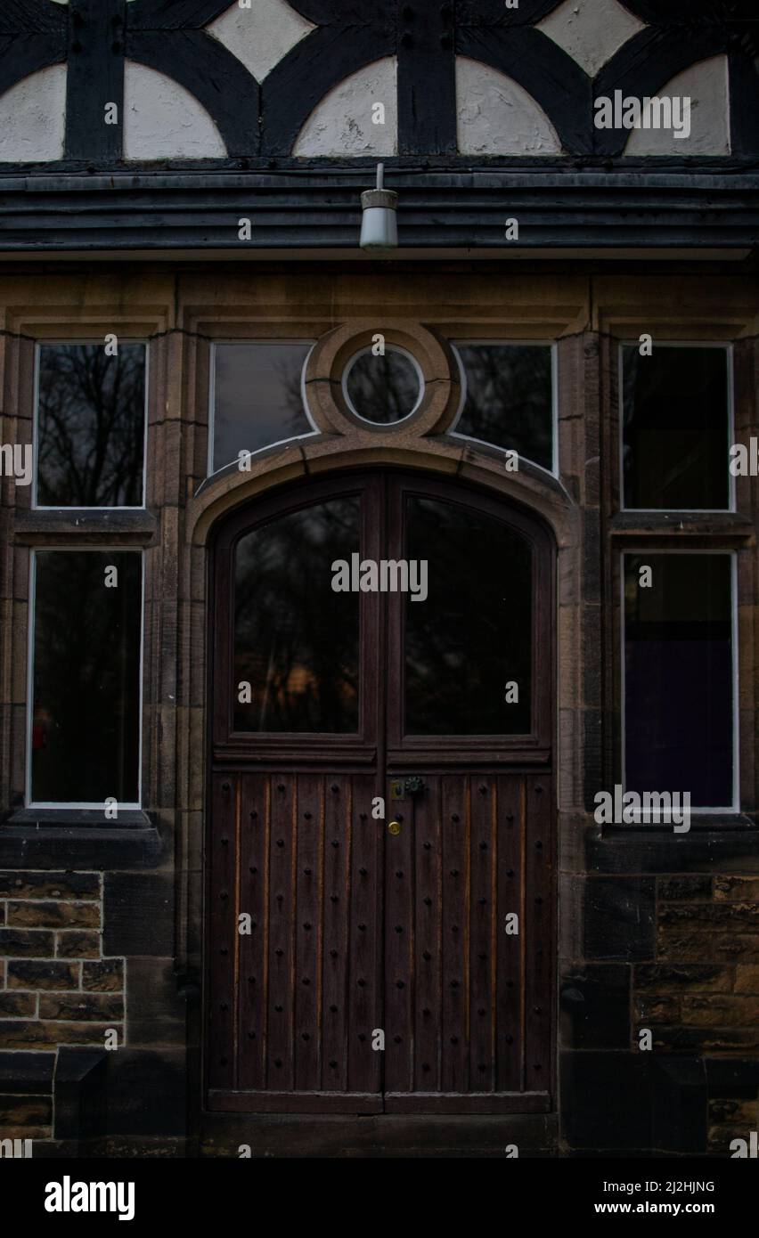 Symmetrical Picture of a doorway with original stonework, woodwork and glass work at Smithills Hall, Bolton. Stock Photo