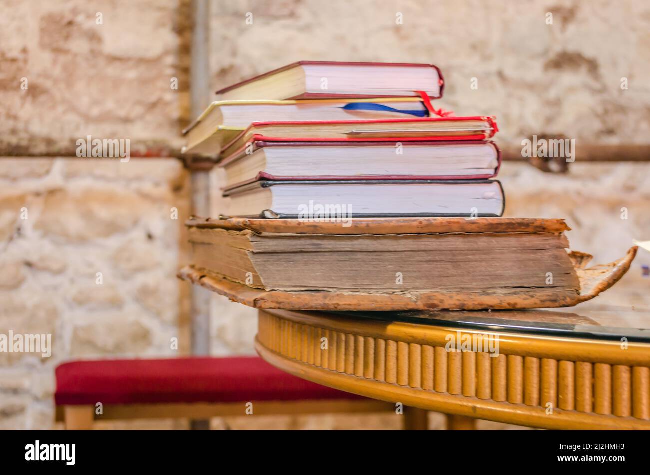 One on top of the other, a pile of stacked old dilapidated books. Stock Photo
