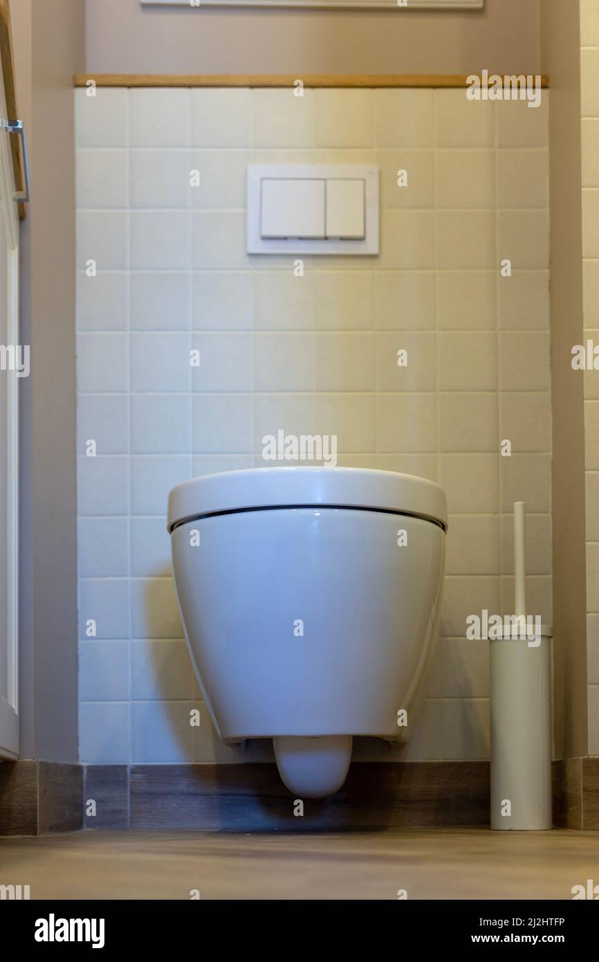 Toilet bowl with closed lid. Toilet in the apartment Stock Photo Alamy