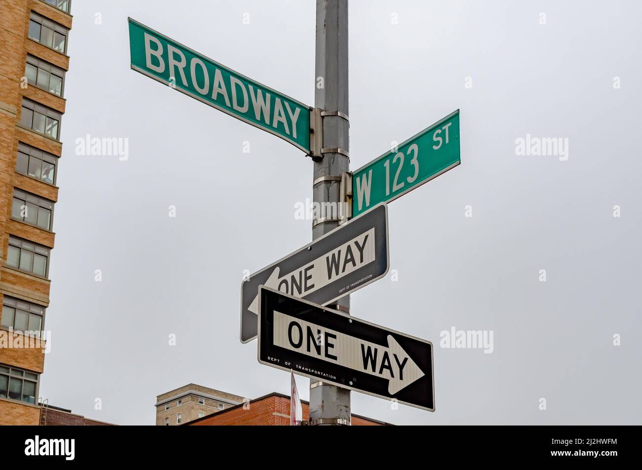 A low angle closeup shot of the Broadway street sign and one way sign