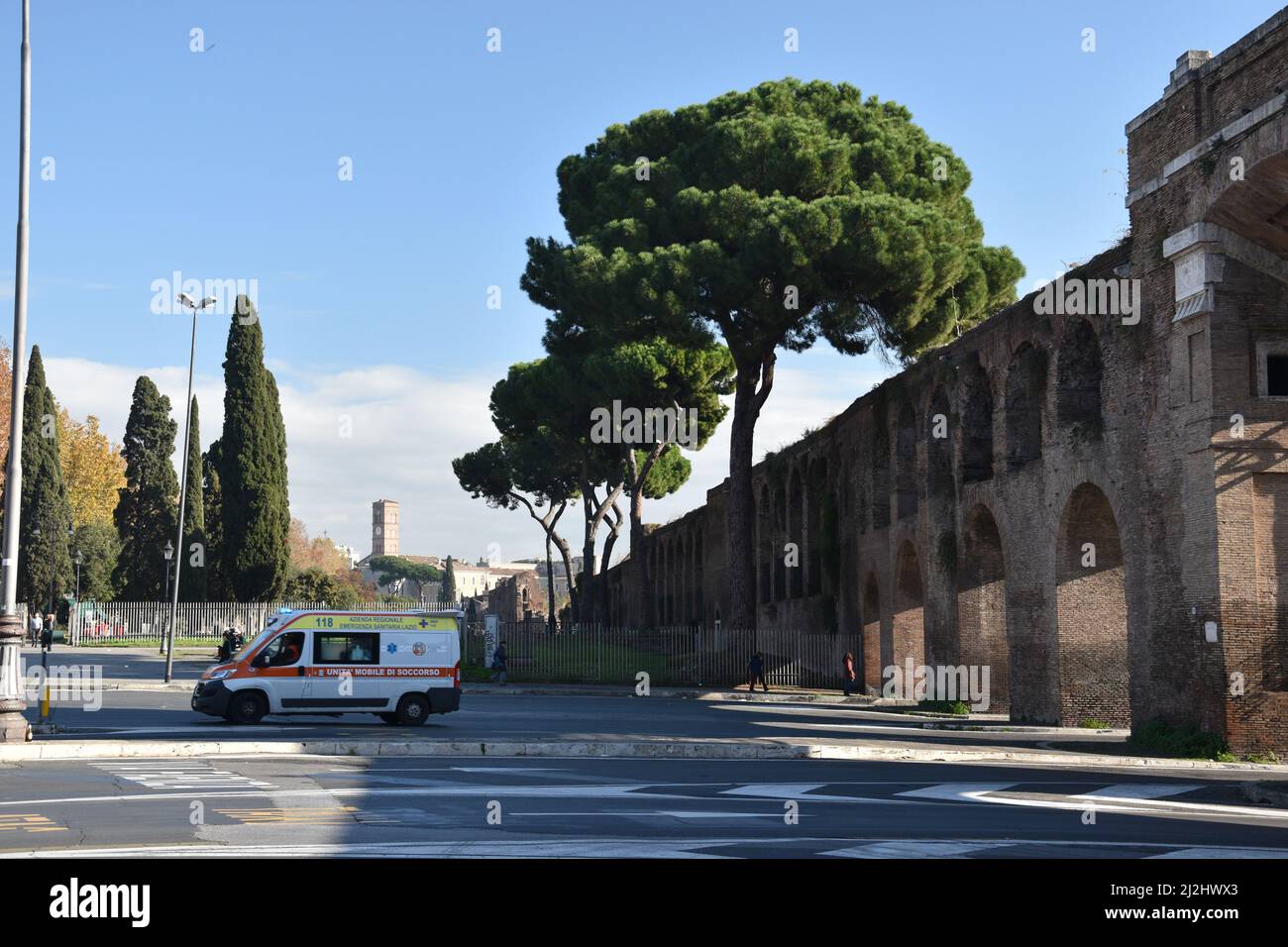 A contrast between modern and ancient times. An ambulance passes through the Aurelian Walls built between 27 and 275 AD. Rome, Italy, November 24, 201 Stock Photo