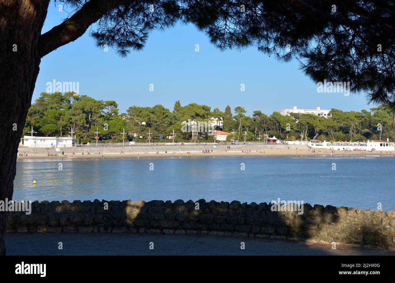 Nauzan beach in a frame of foliage at Saint Palais,a commune in the Charente-Maritime department in southwestern France. Stock Photo