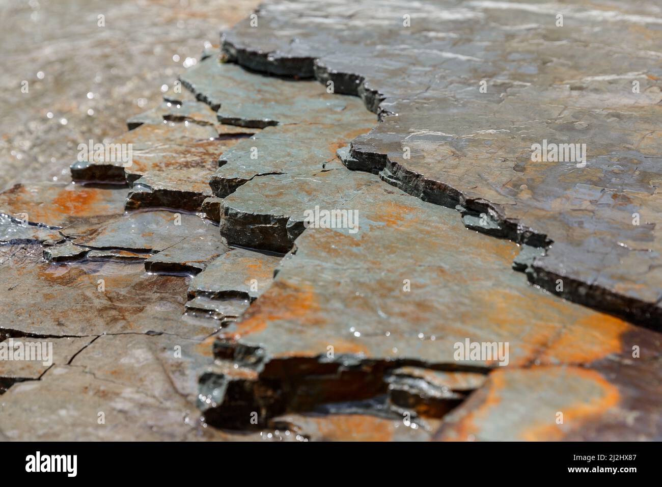 Background Shale rock with layered slate forming banks of Prut river in Carpathians, Ukraine Stock Photo