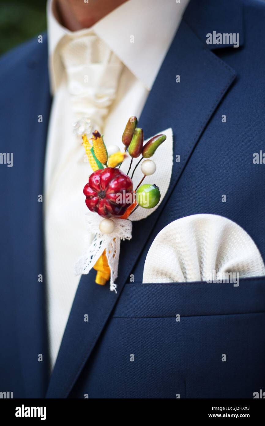 Mexican style boutonniere close up. Groom in blue suit. Creative floristic solution. Wedding trends. Stock Photo