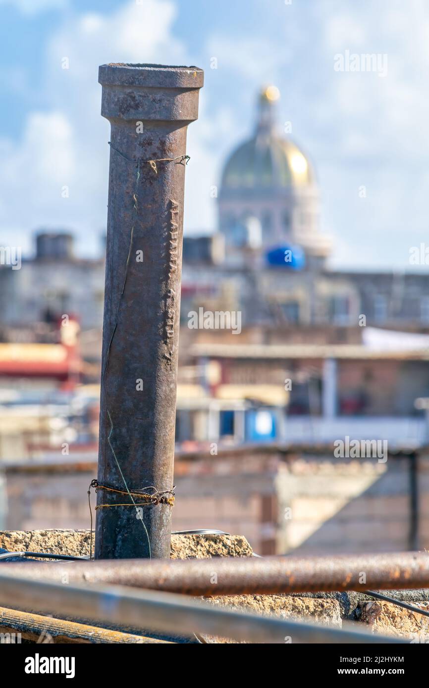Cast iron bathroom vent tube seen on a rooftop of an apartment building in the Cuban capital city. The metallic element reads 'Alabama 4' Std. 7'. El Stock Photo