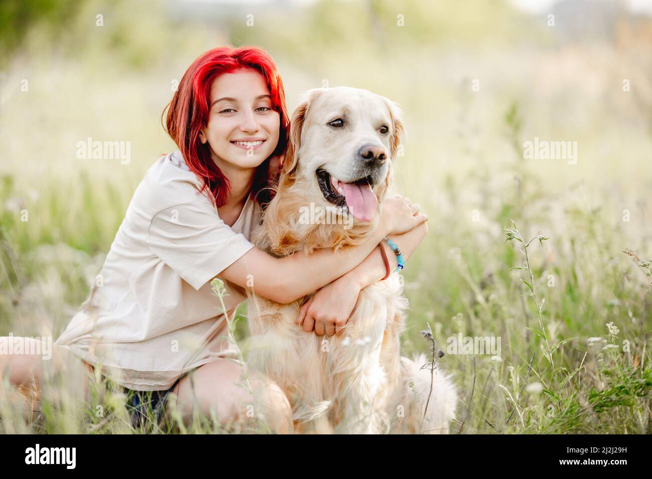 Teen girl with golden retriever dog Stock Photo - Alamy