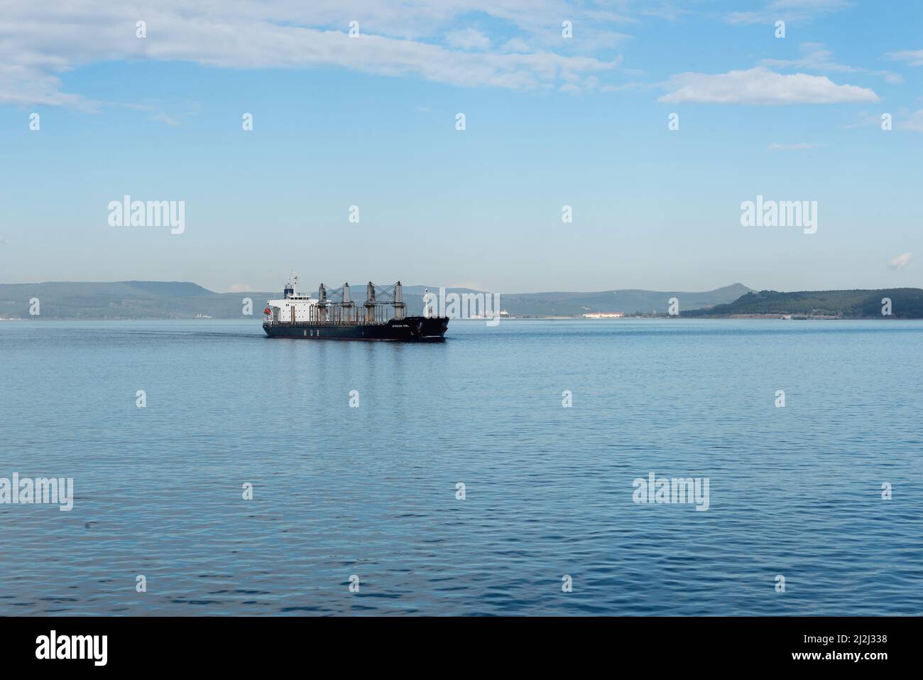 Canakkale, Turkey. February 18th 2022 The African Owl bulk cargo ship passing through the Dardanelles straight near the Gallipoli Peninsular and the T Stock Photo
