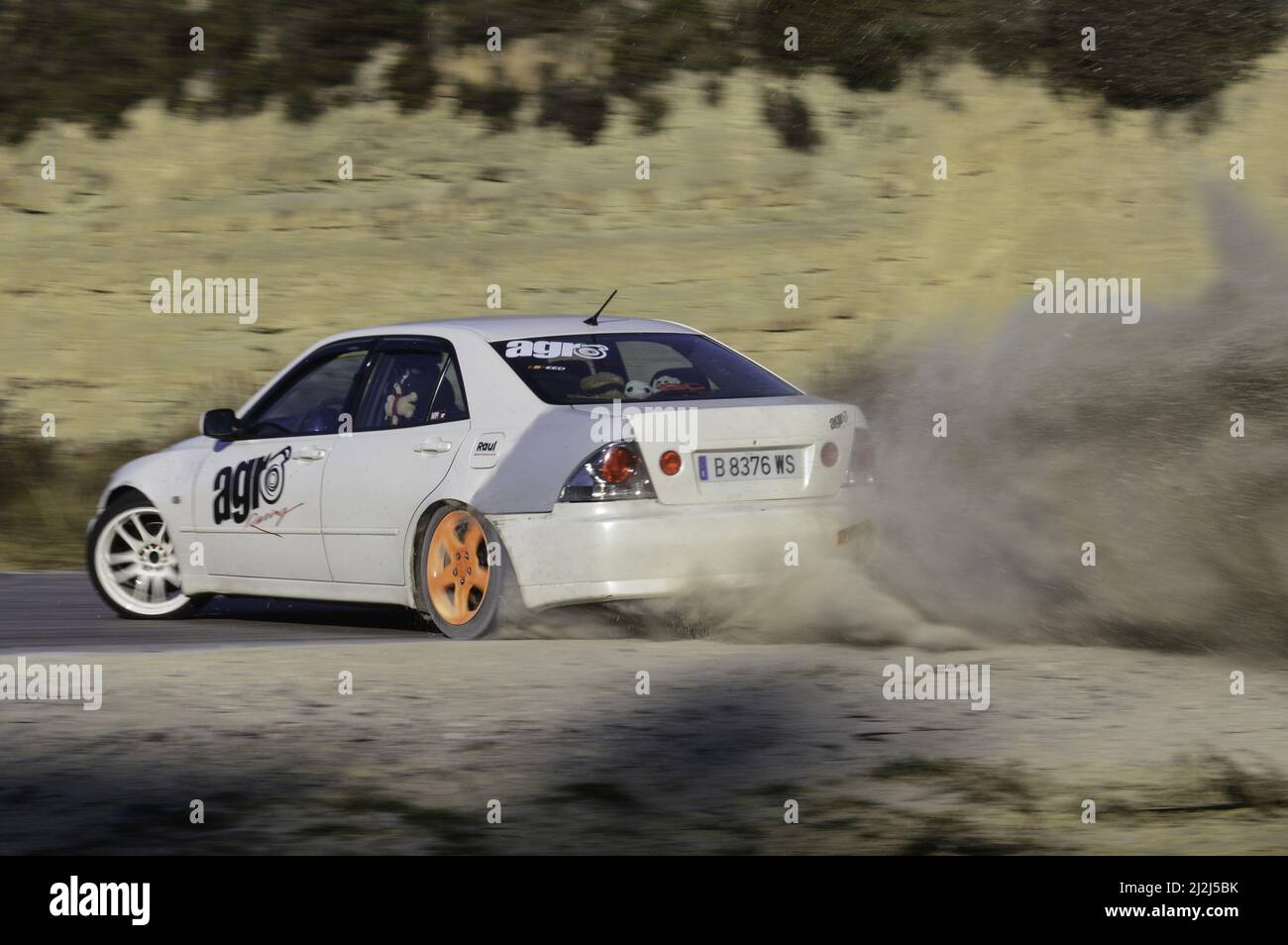 A custom street car drifting on the track lifting dust. Lexus IS200 Stock Photo