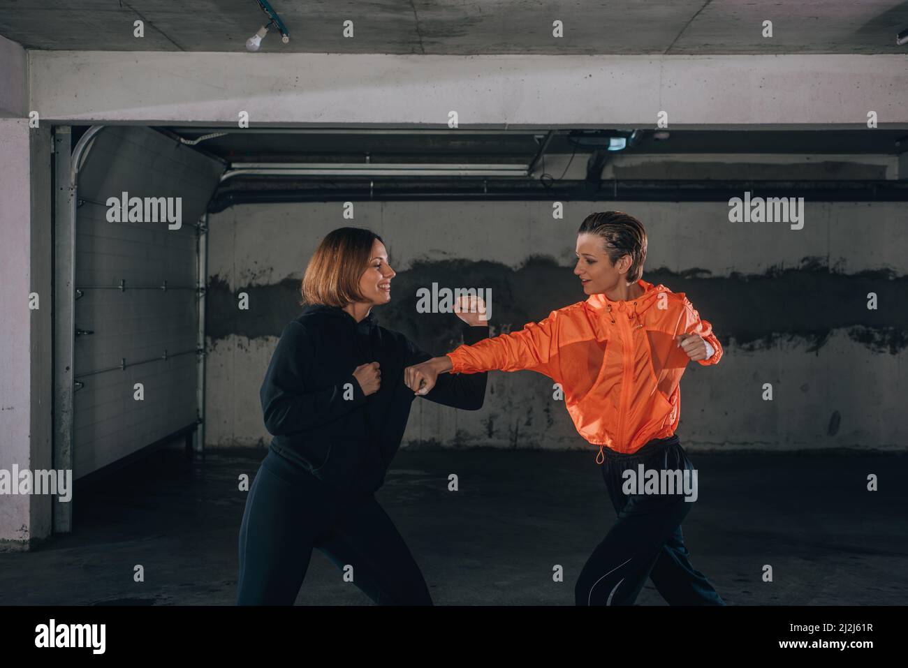 two-female-athletes-showing-technical-skills-while-practicing-fighting