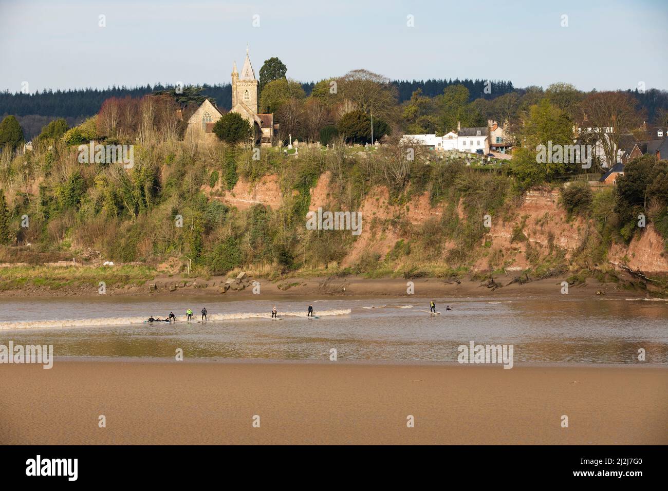 Arlingham, Gloucestershire. United Kingdom. 2nd Apr 2022. Surfers brave the cold waters of the River Severn at Spring Tide to catch the Severn Bore. A natural phenomena that occurs when the tide pushes back against the outflowing river creating a wave. Arlingham. Gloucestershire. United Kingdom. 2nd Apr 2022. Image by: Alexander Caminada. Credit: Alexander Caminada/Alamy Live News Stock Photo