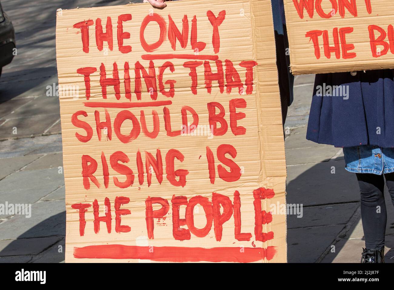 'The only thing that should be rising is the people' strikers cardboard sign in Preston, Lancashire. UK Politics. 02 April, 2022. PCS union members and other trade unionists bring handmade placards to the Flag Market to protest about the privatisation of the NHS  The NHS in England is about to be reorganised, after the government published the Health and Care Bill in July 2021. The Bill proposes changes to NHS rules and structures in England and the government wants the changes to be in place by April 2022. Stock Photo
