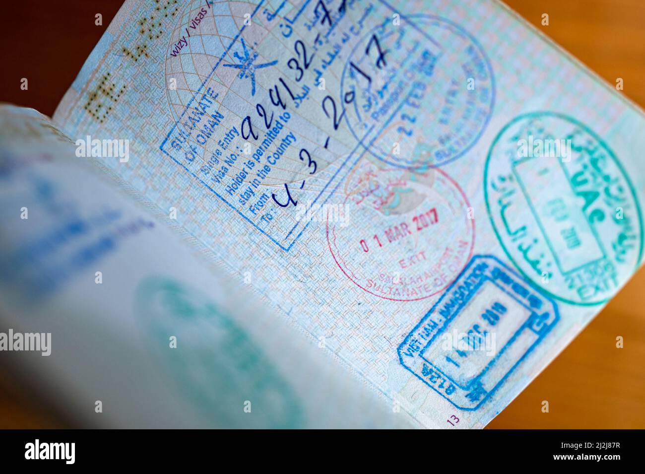 Immigration border stamps from Oman, UAE and Vietnam in the passport