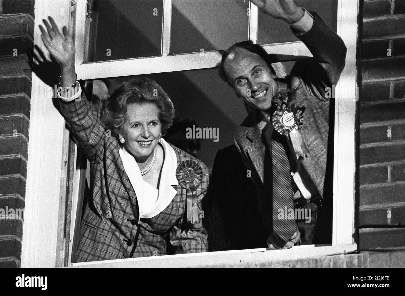 Prime Minister Margaret Thatcher  and Conservative Party chairman, Norman Tebbit, celebrate winning a third term in government for the Conservative Party, from a window at Conservative Central Office in Smith Square, Westminster. 12 June 1987. Stock Photo