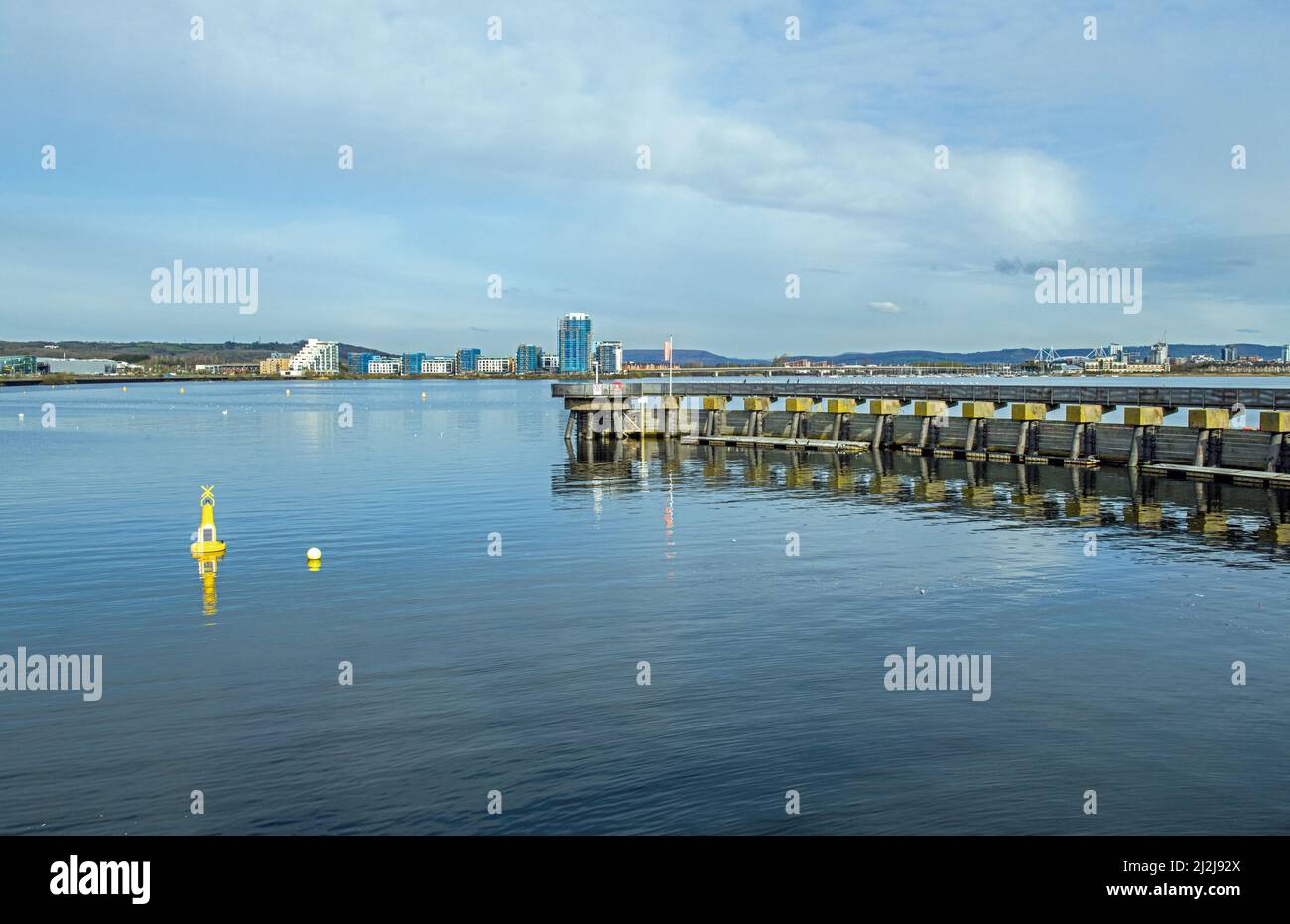 The view across Cardiff Bay from the Cardiff Bay Barrage walk on a sunny April morning Stock Photo