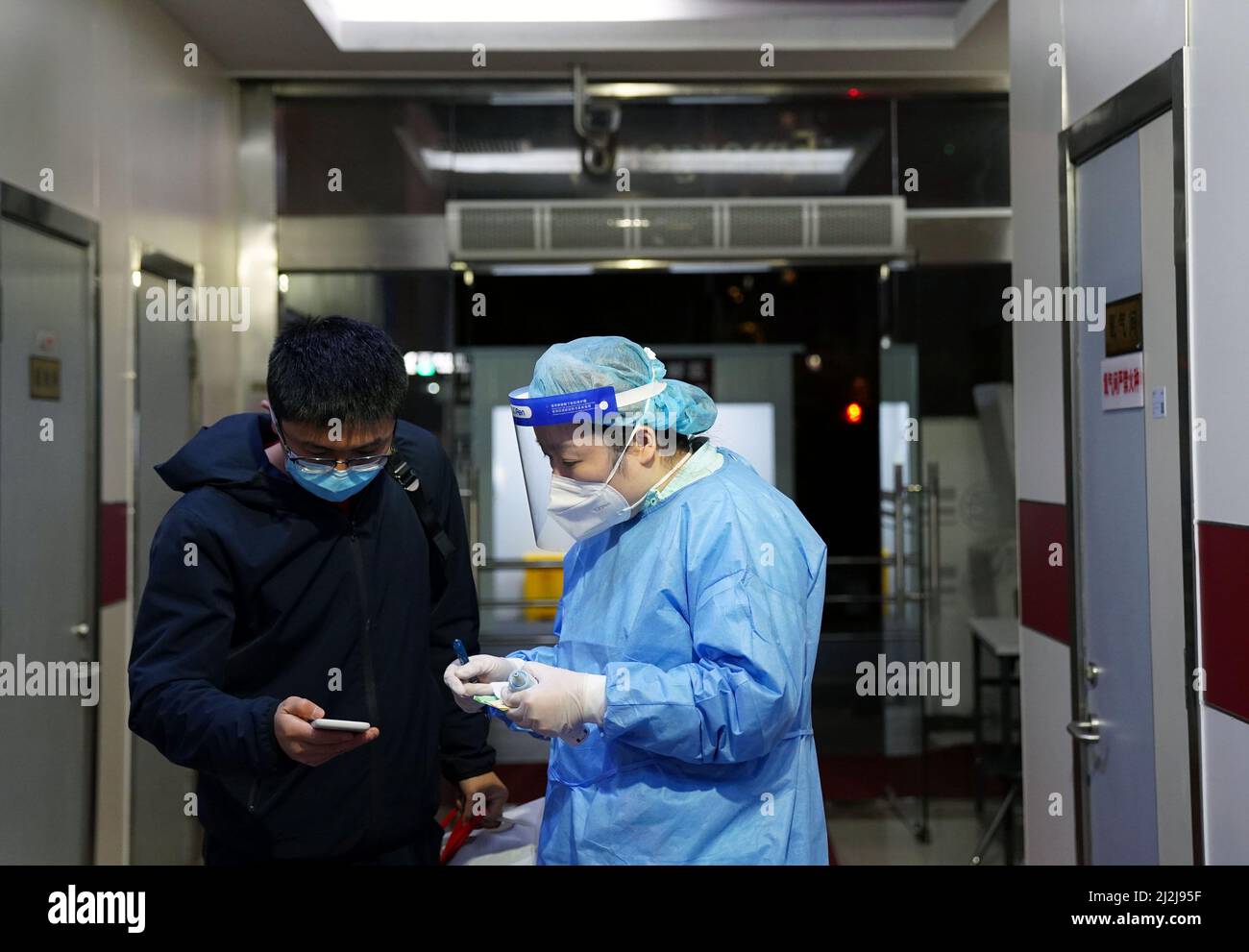 Shanghai. 1st Apr, 2022. A nurse enquires about a pregnant woman's information from her relative at the emergency clinic of the International Peace Maternity & Child Health Hospital of China welfare institute in east China's Shanghai, April 1, 2022. The emergency clinic of the hospital has scaled up efforts to ensure pregnant women can timeously get medical help. Around 40 babies were delivered Friday at the hospital. Credit: Yuan Quan/Xinhua/Alamy Live News Stock Photo