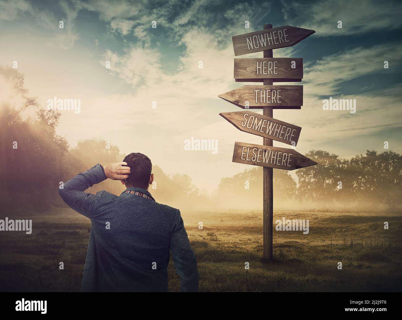 Lost and confused businessman in front of a signpost showing impossible directions. Business dilemma and difficult choice concept. Choosing the correc Stock Photo