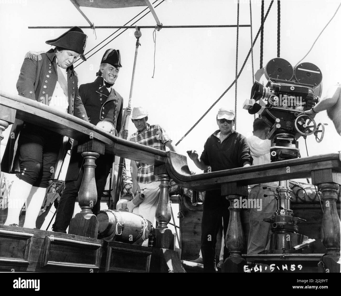 Star and Director PETER USTINOV and PAUL ROGERS on set candid on ship during filming of BILLY BUDD 1962 director PETER USTINOV novel Hermann Melville cinematographer Robert Krasker Anglo Allied / Allied Artists Pictures Stock Photo
