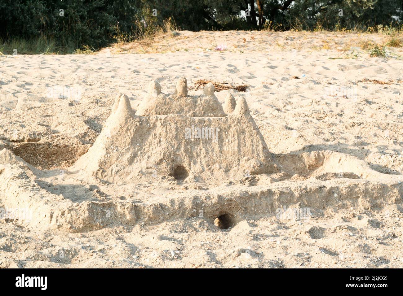 Sand castle at the beach on a sunny day. Built house sand castle. Sand