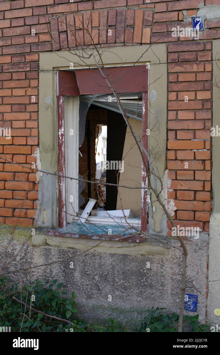 View through an empty window frame into a condemned house Stock Photo ...
