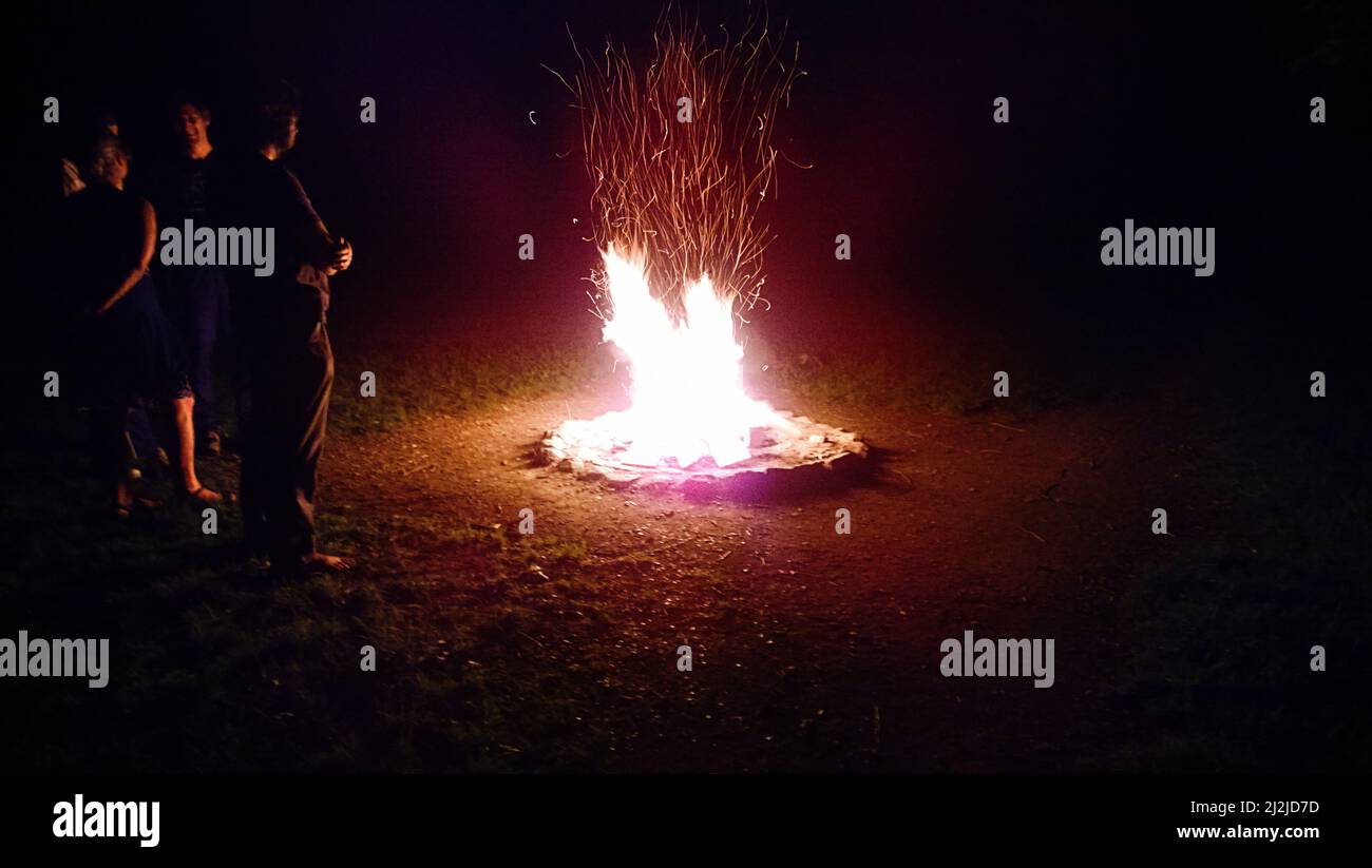 People make a summer night bonfire on the beach Stock Photo