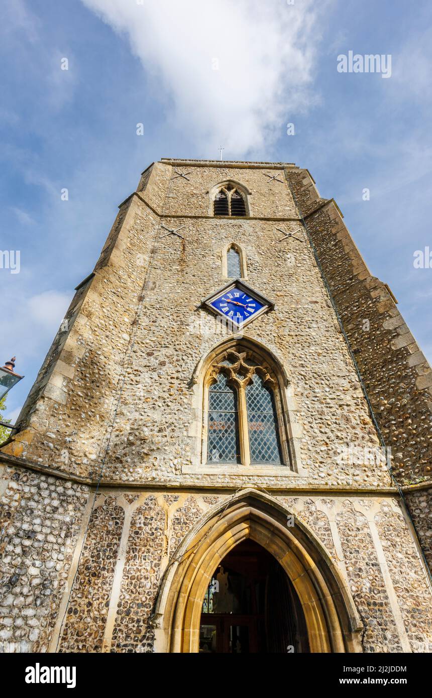 The flint and stone tower of the parish Church of St Andrew the Apostle in Holt, a small historic Georgian market town in north Norfolk, England Stock Photo