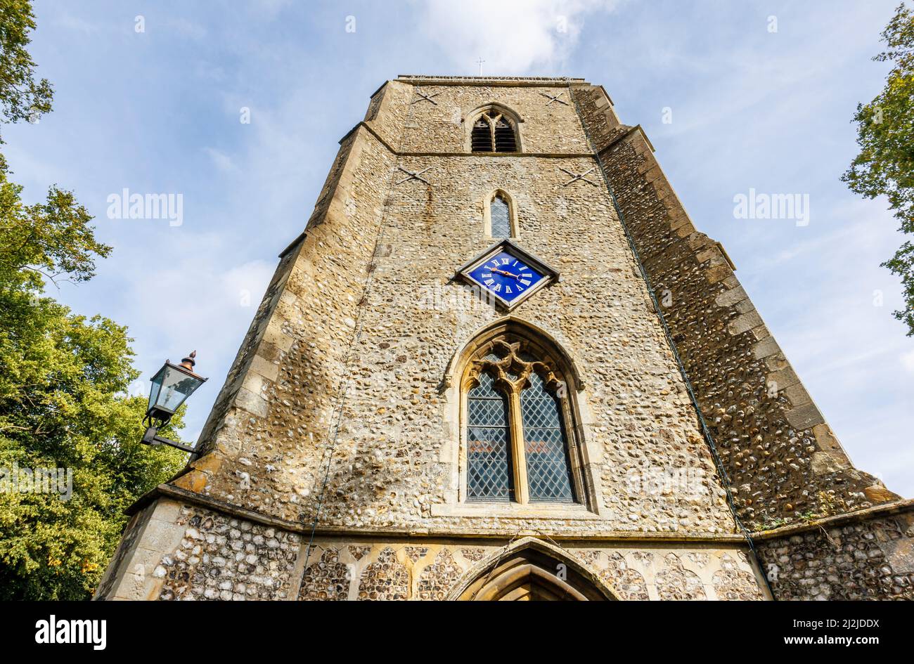 The flint and stone tower of the parish Church of St Andrew the Apostle in Holt, a small historic Georgian market town in north Norfolk, England Stock Photo