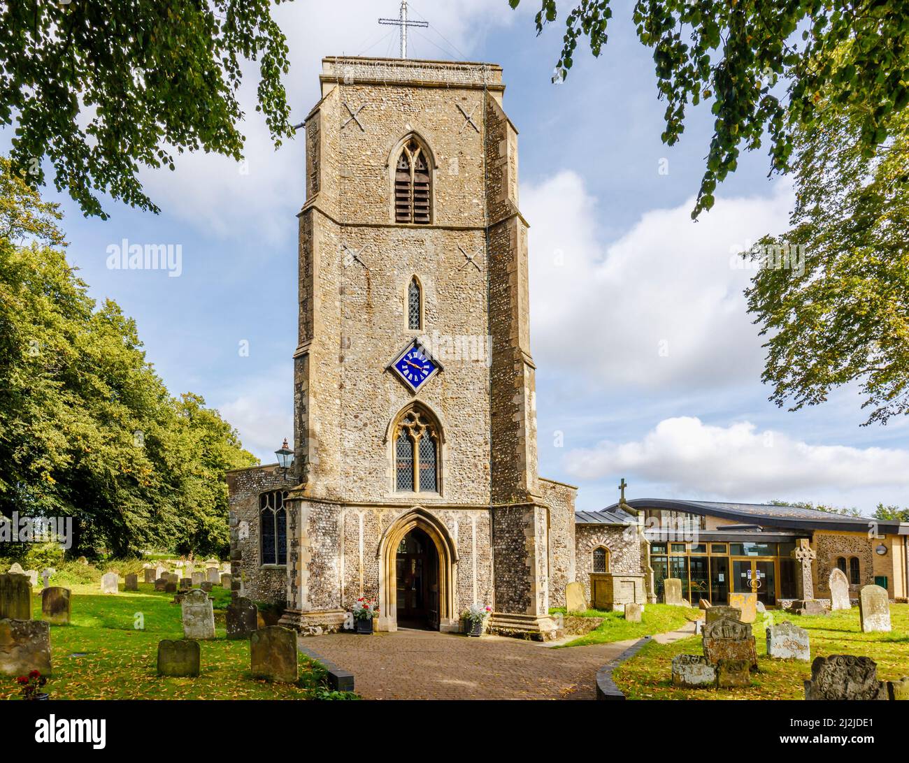 The flint and stone exterior of the parish Church of St Andrew the Apostle in Holt, a small historic Georgian market town in north Norfolk, England Stock Photo