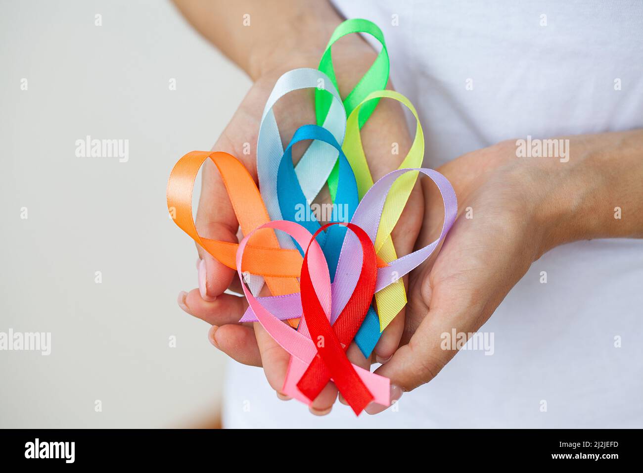 Female doctor holds colored ribbons symbolize awareness of various ...