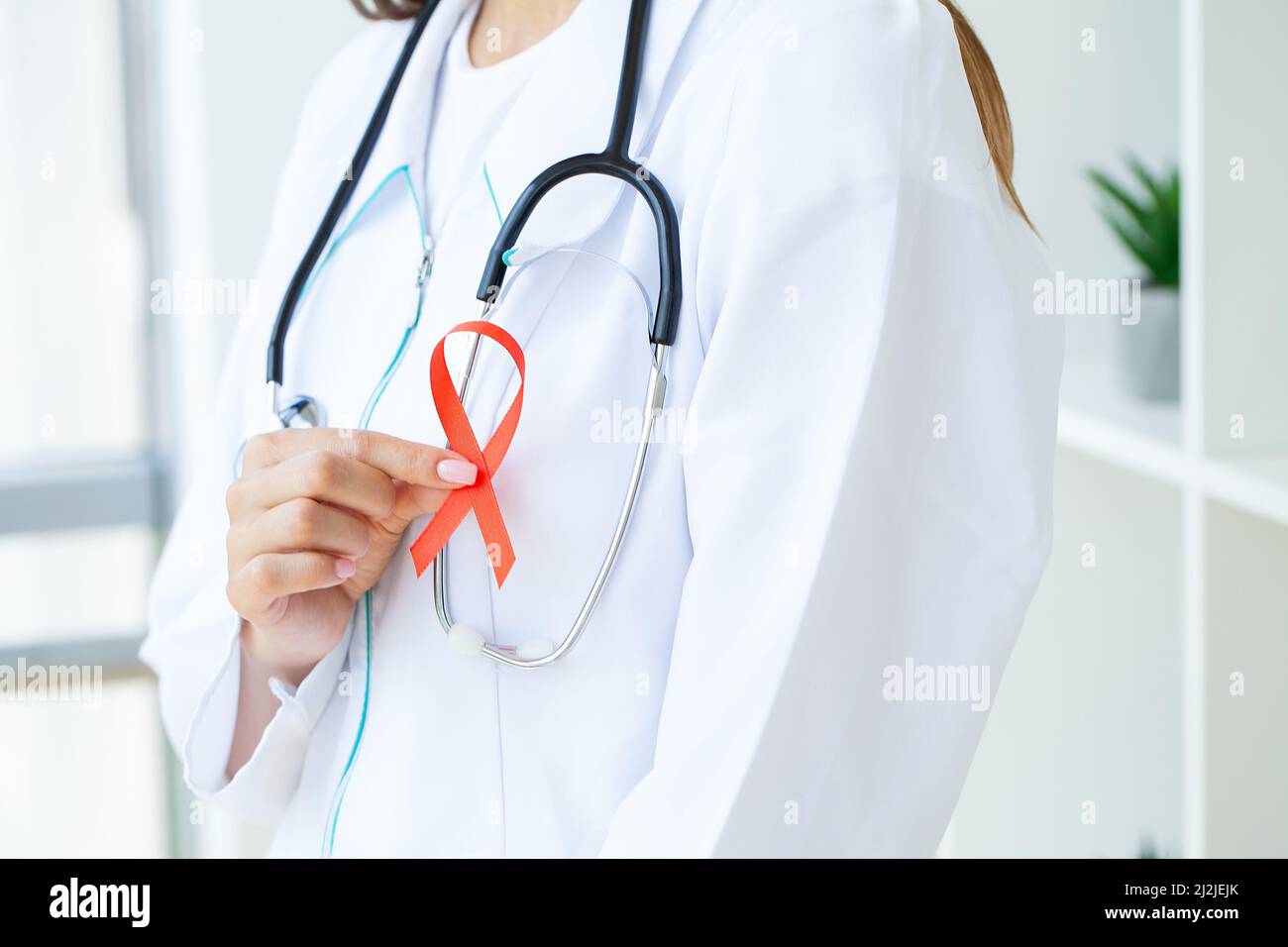 Woman hand holding red ribbon HIV world AIDS day awareness ribbon Stock ...