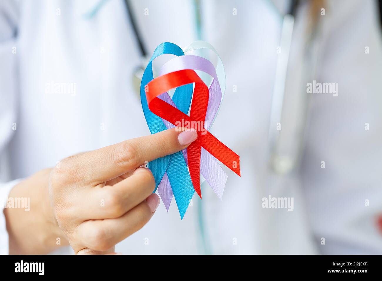 Female doctor holds colored ribbons symbolize awareness of various diseases Stock Photo Alamy