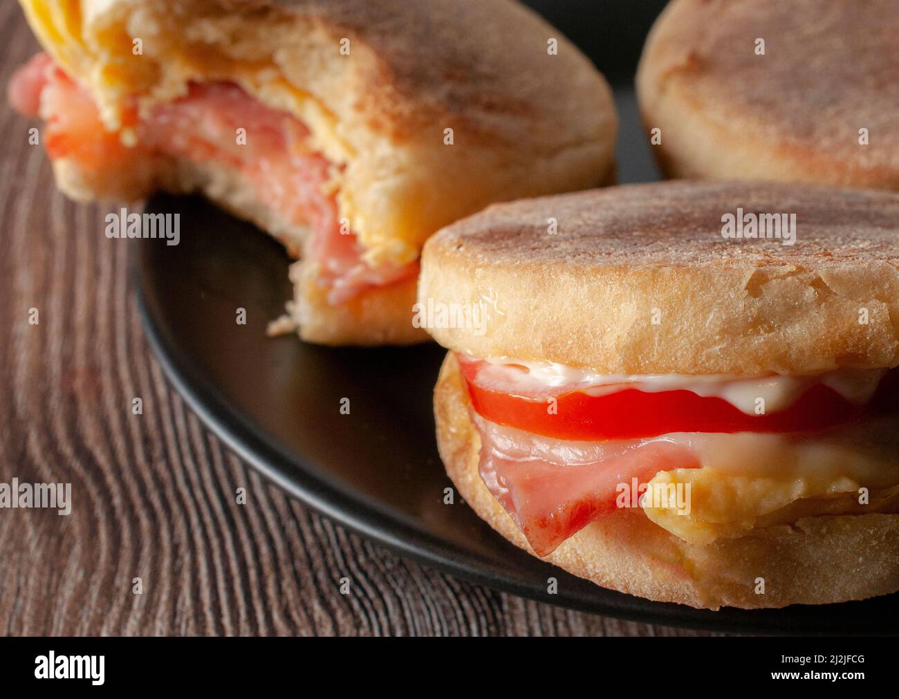 English muffin with egg ham tomato mayo and cheese macro photography