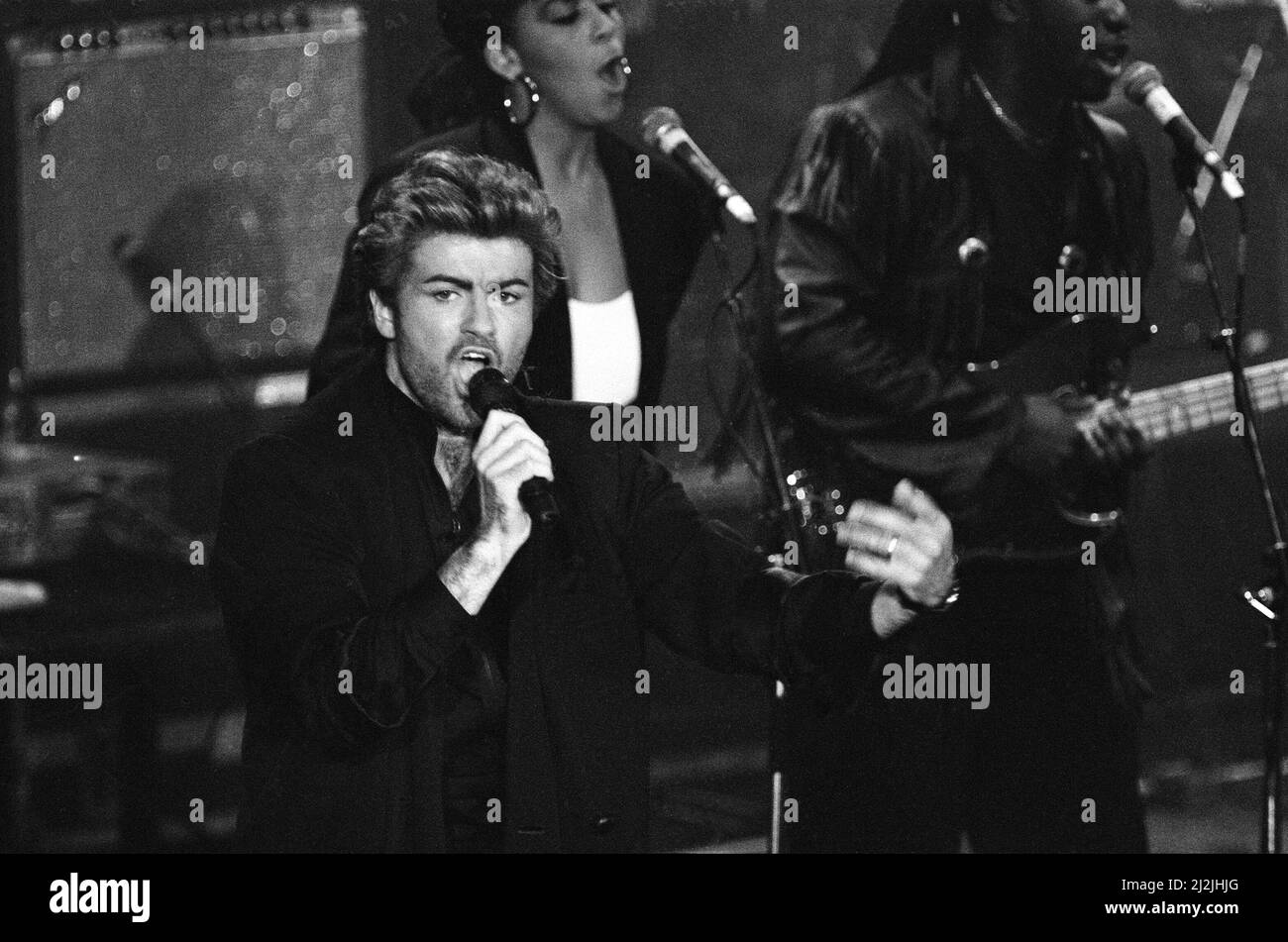 George Michael performing at the Stand by Me: AIDS Day Benefit concert at Wembley Arena, London. 1st April 1987. Stock Photo
