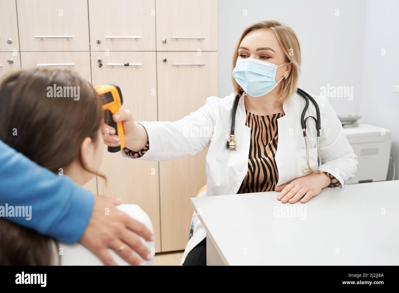 Female doctor checking child temperature in clinic Stock Photo Alamy