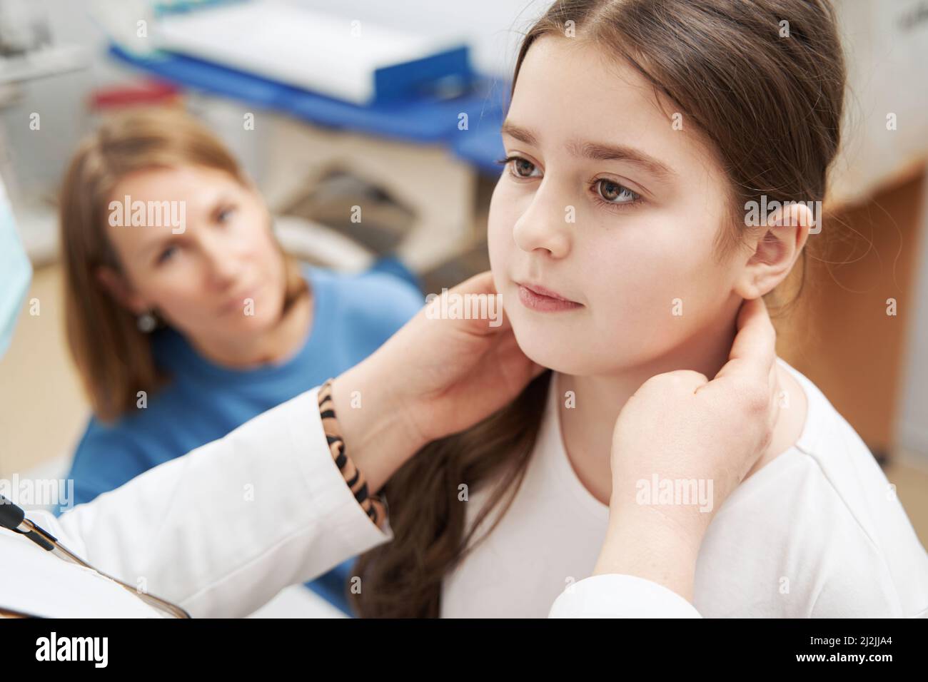 Female doctor examining child lymph nodes in clinic Stock Photo
