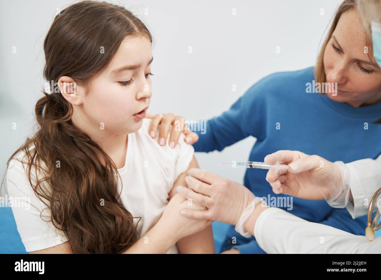 Little girl getting injection in pediatric clinic Stock Photo Alamy