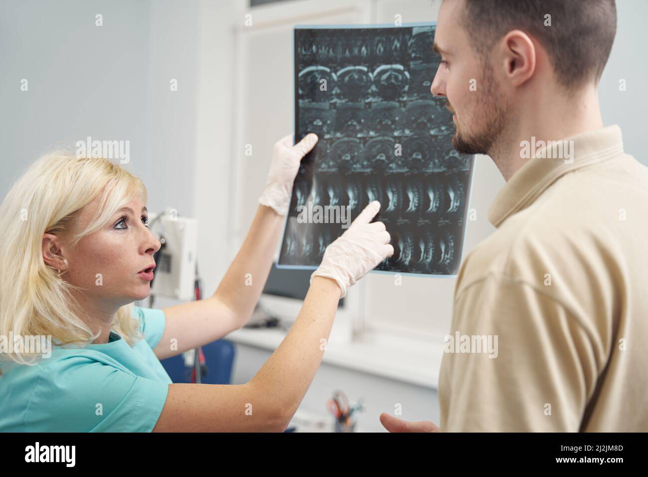 Female doctor showing spine xray to young man Stock Photo Alamy