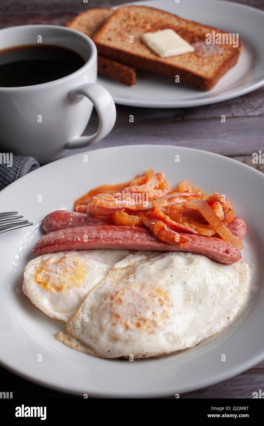 well done fried eggs with sausage and tomato and onion spicy salsa on a