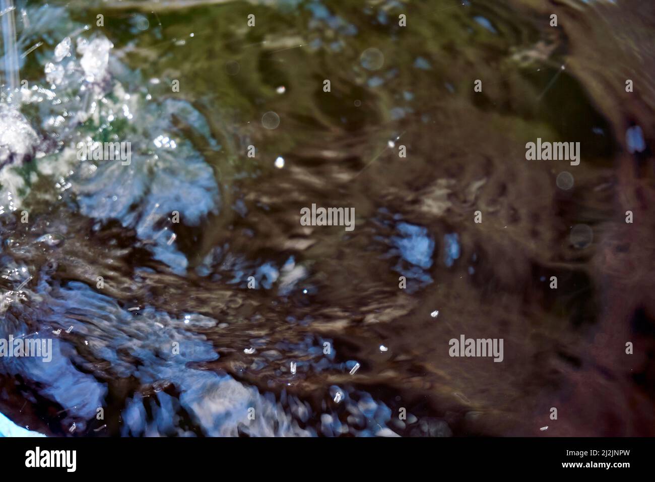 Big puddle: the rain drops falling in a puddle and drops of water on ...